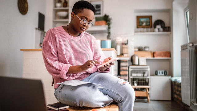 Woman doing home finances at home in the morning 