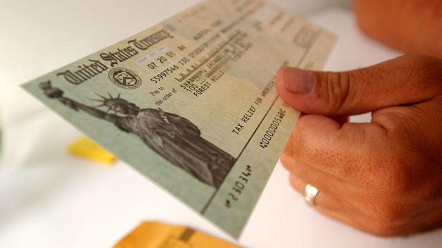 A taxpayer looks at his rebate check on July 25, 2001, in New York City. 