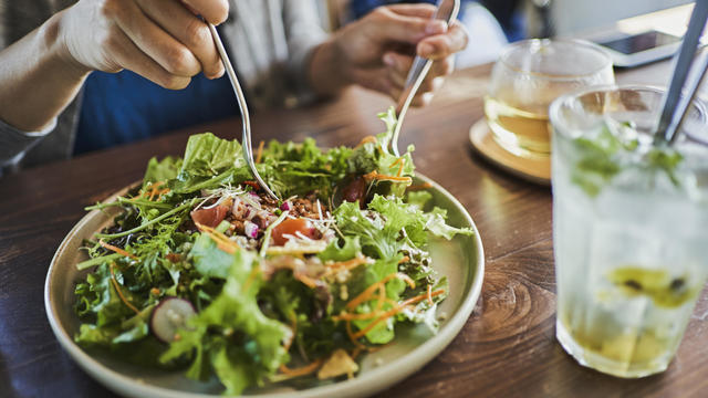 Japanese woman eating a vegan lunch at a vegan cafe 